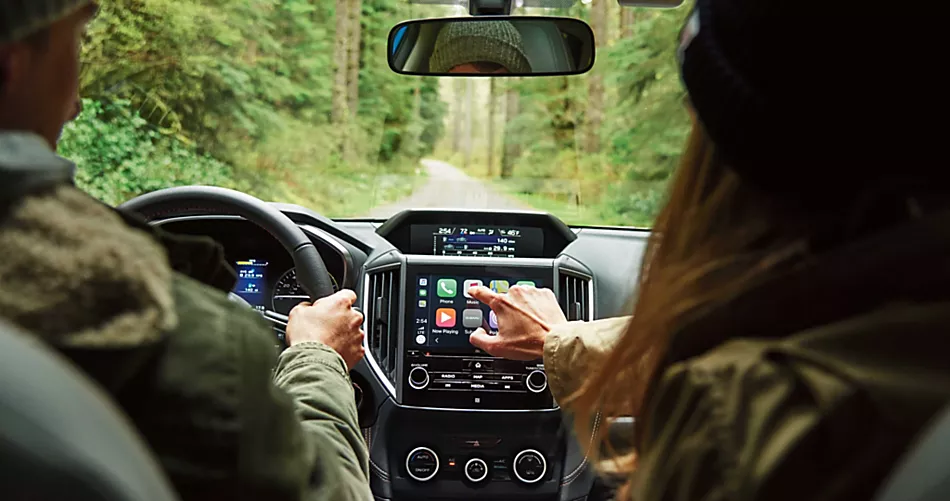 MY20 CTK Front Seat Perspective Couple Driving in Woods